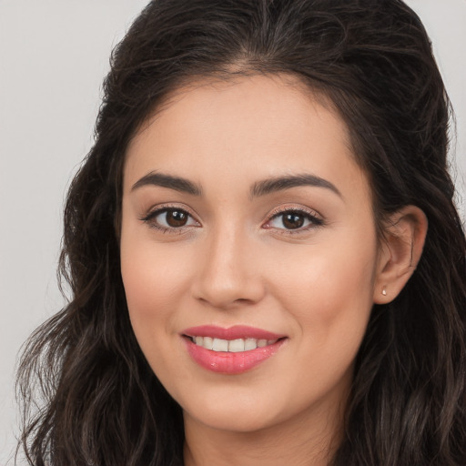 Joyful white young-adult female with long  brown hair and brown eyes