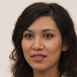 Joyful asian young-adult female with long  brown hair and brown eyes