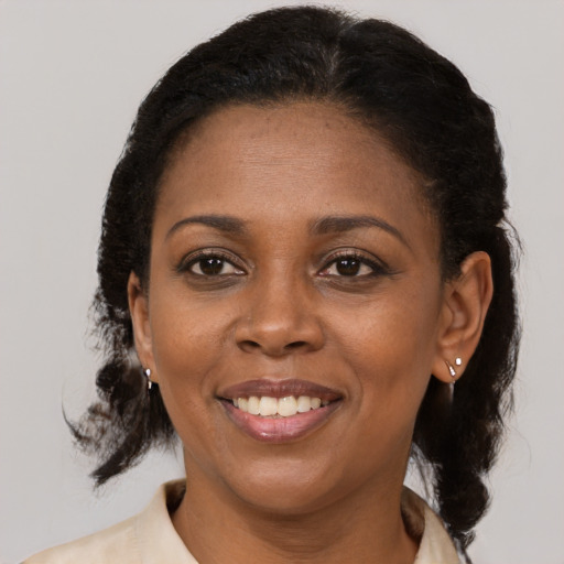 Joyful latino adult female with medium  brown hair and brown eyes