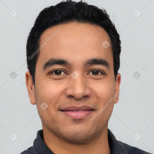 Joyful latino young-adult male with short  black hair and brown eyes