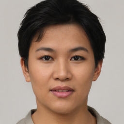 Joyful asian young-adult female with short  black hair and brown eyes