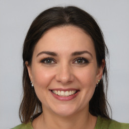 Joyful white young-adult female with medium  brown hair and brown eyes