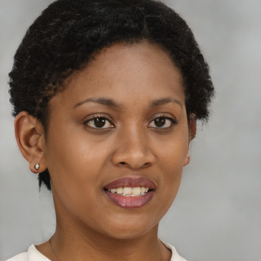 Joyful black young-adult female with short  brown hair and brown eyes