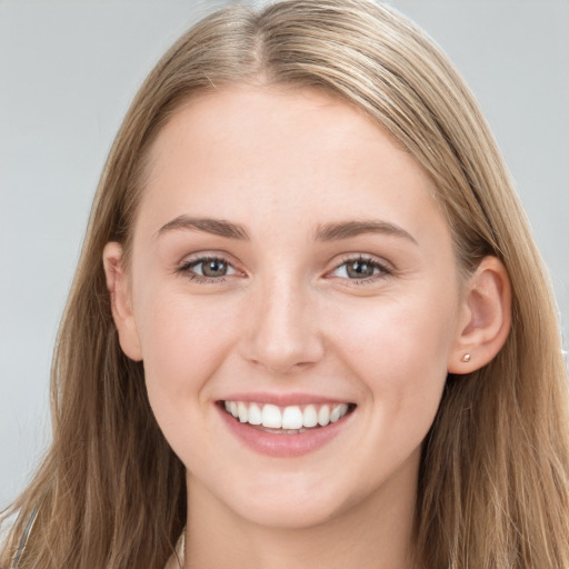 Joyful white young-adult female with long  brown hair and grey eyes