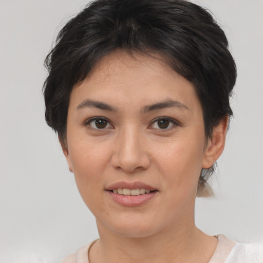 Joyful asian young-adult female with short  brown hair and brown eyes