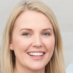 Joyful white young-adult female with long  brown hair and blue eyes