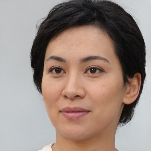 Joyful asian young-adult female with medium  brown hair and brown eyes