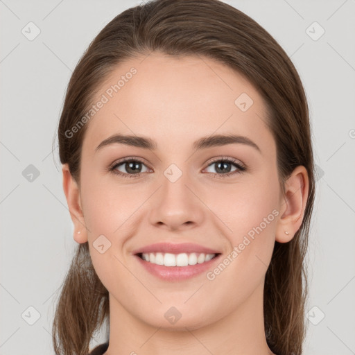 Joyful white young-adult female with long  brown hair and grey eyes