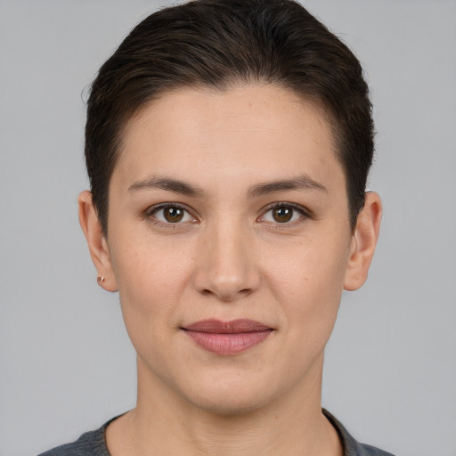 Joyful white young-adult female with short  brown hair and brown eyes
