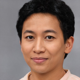 Joyful asian young-adult male with short  black hair and brown eyes