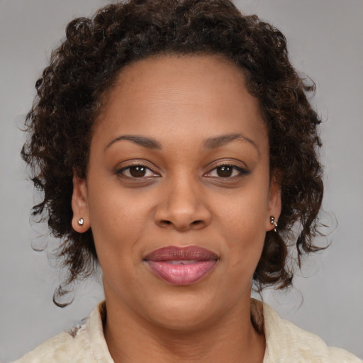 Joyful black adult female with medium  brown hair and brown eyes