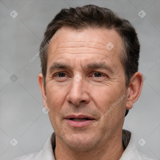 Joyful white adult male with short  brown hair and brown eyes