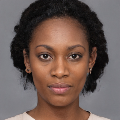 Joyful black young-adult female with medium  black hair and brown eyes