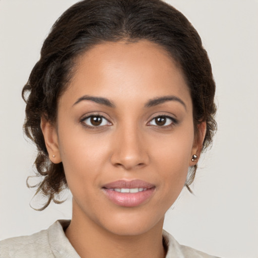 Joyful latino young-adult female with medium  brown hair and brown eyes