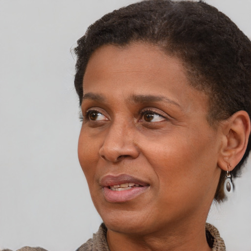 Joyful latino adult female with short  brown hair and brown eyes