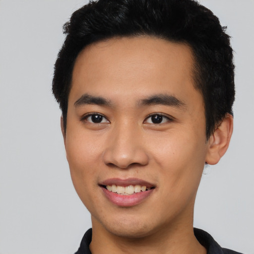 Joyful asian young-adult male with short  black hair and brown eyes