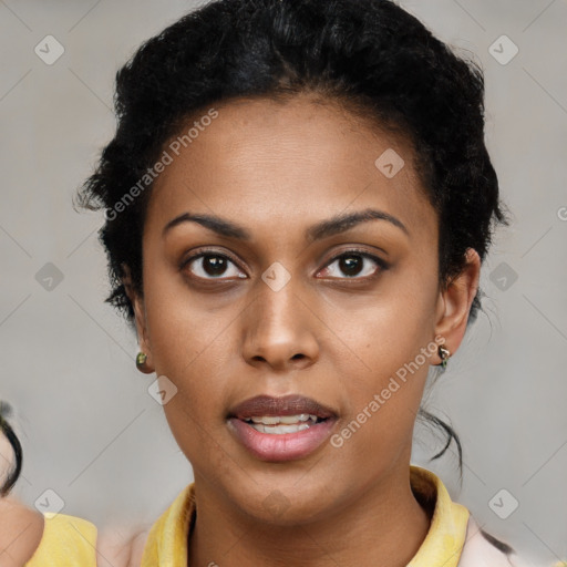 Joyful black young-adult female with short  brown hair and brown eyes