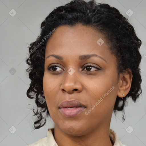 Joyful black young-adult female with medium  black hair and brown eyes