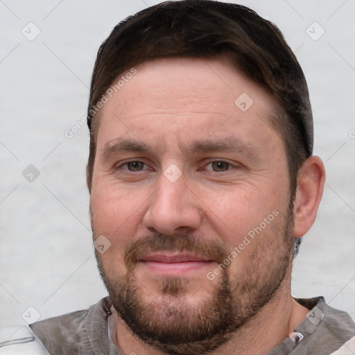 Joyful white adult male with short  brown hair and grey eyes