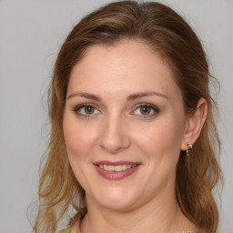 Joyful white young-adult female with medium  brown hair and green eyes