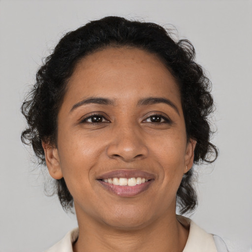 Joyful latino young-adult female with medium  brown hair and brown eyes
