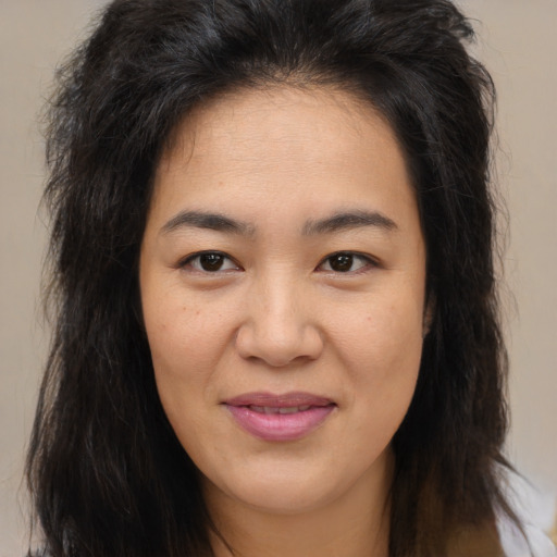 Joyful asian young-adult female with long  brown hair and brown eyes