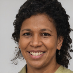 Joyful black adult female with medium  brown hair and brown eyes