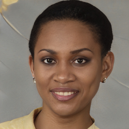 Joyful black young-adult female with short  brown hair and brown eyes