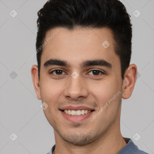 Joyful white young-adult male with short  black hair and brown eyes