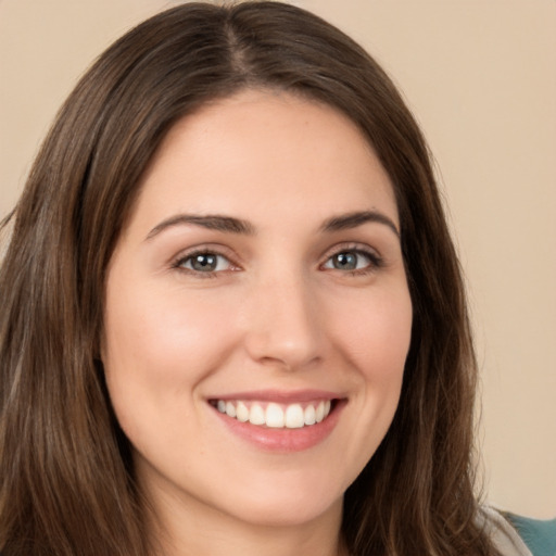 Joyful white young-adult female with long  brown hair and brown eyes