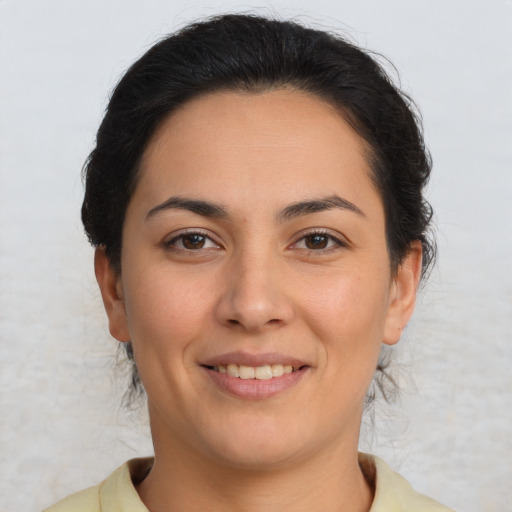 Joyful latino young-adult female with short  brown hair and brown eyes