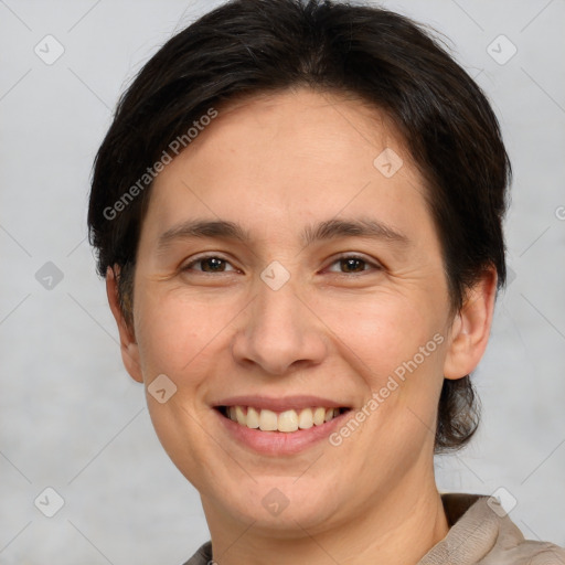 Joyful white adult female with short  brown hair and brown eyes