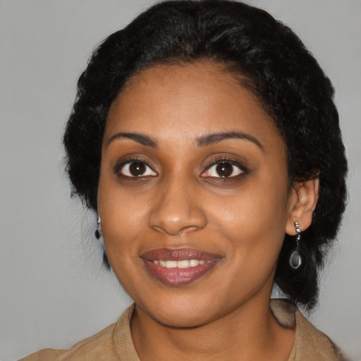 Joyful black young-adult female with medium  black hair and brown eyes