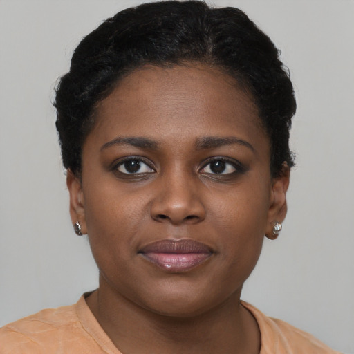 Joyful black young-adult female with short  brown hair and brown eyes