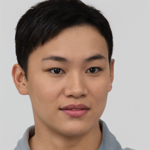 Joyful asian young-adult female with short  brown hair and brown eyes
