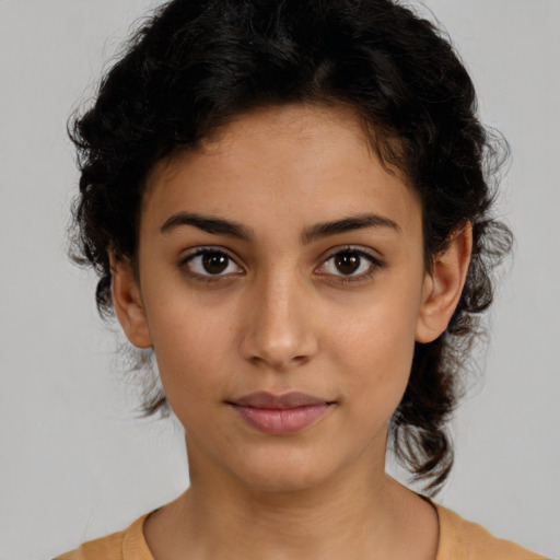 Joyful latino young-adult female with medium  brown hair and brown eyes