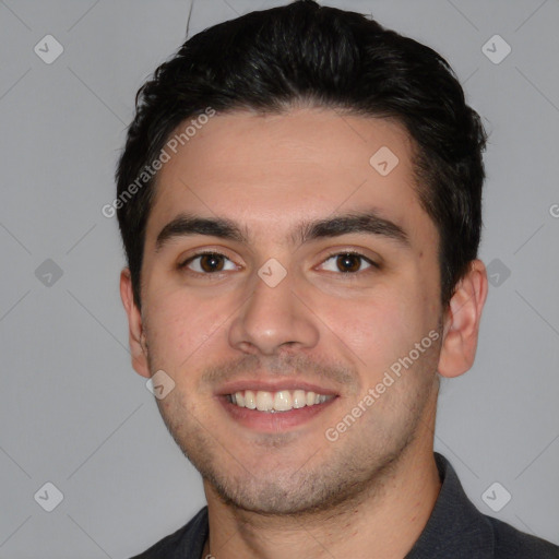 Joyful white young-adult male with short  black hair and brown eyes