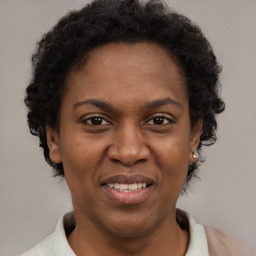 Joyful black adult female with short  brown hair and brown eyes