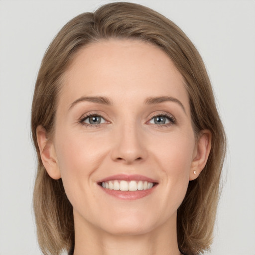 Joyful white young-adult female with medium  brown hair and grey eyes