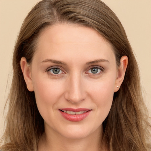 Joyful white young-adult female with long  brown hair and blue eyes