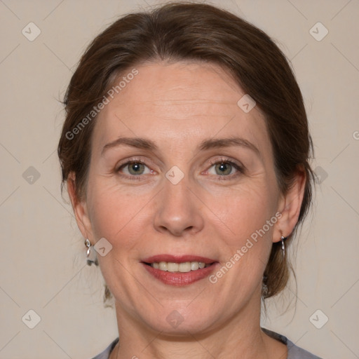 Joyful white adult female with medium  brown hair and blue eyes