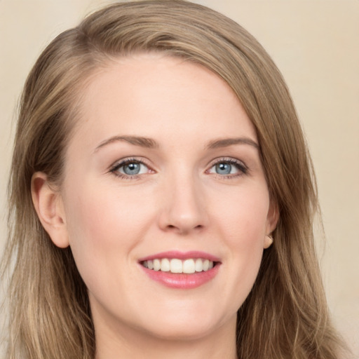 Joyful white young-adult female with long  brown hair and green eyes