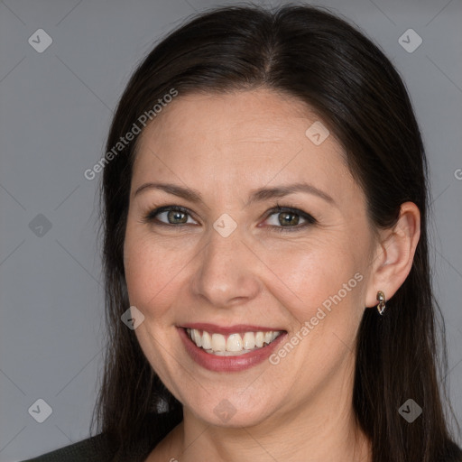 Joyful white adult female with long  brown hair and brown eyes