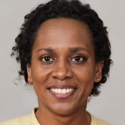 Joyful black adult female with short  brown hair and brown eyes