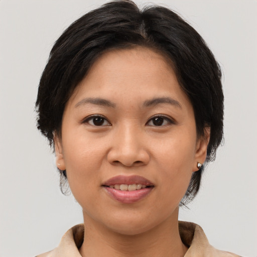 Joyful asian young-adult female with medium  brown hair and brown eyes