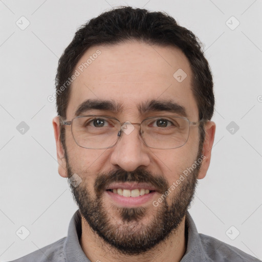 Joyful white adult male with short  black hair and brown eyes