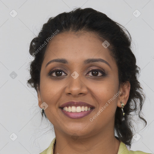 Joyful black young-adult female with long  brown hair and brown eyes