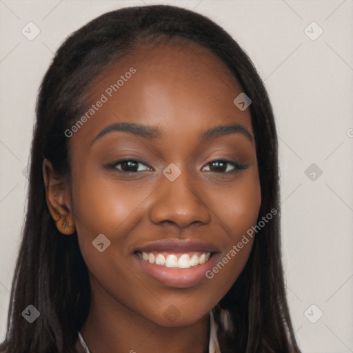 Joyful black young-adult female with long  brown hair and brown eyes