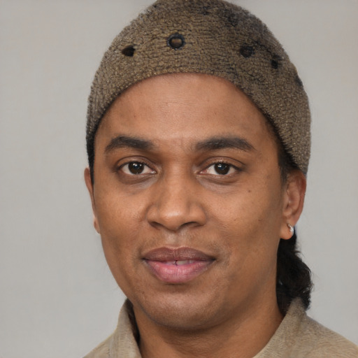 Joyful black adult male with short  black hair and brown eyes