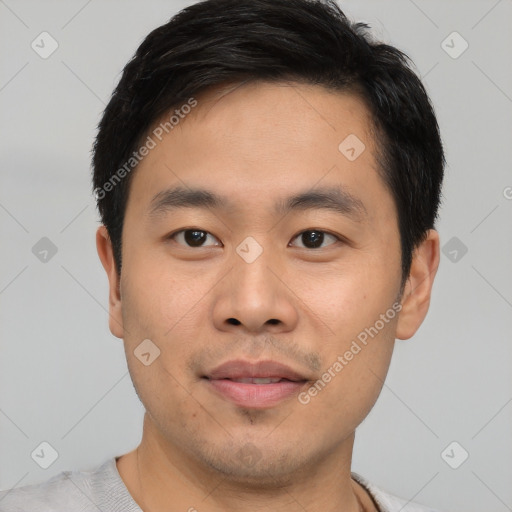 Joyful asian young-adult male with short  black hair and brown eyes